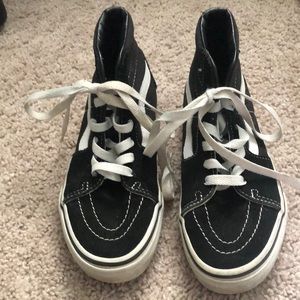 Black and white high top vans